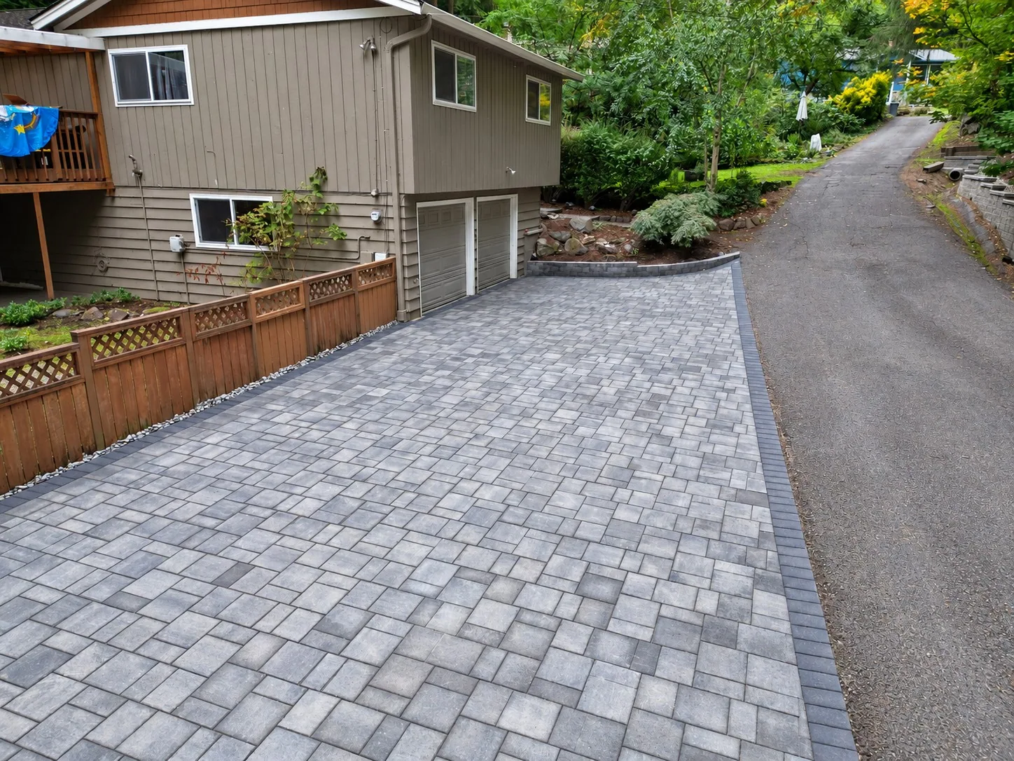 Completed paver driveway with dark accent border